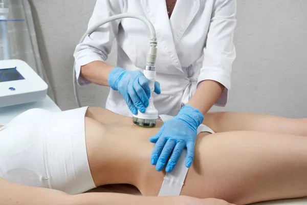 Lost the Weight but Not the Loose Skin? 2 woman having HIFU treatment on her stomach to combat loose skin Smethwick following weight loss
